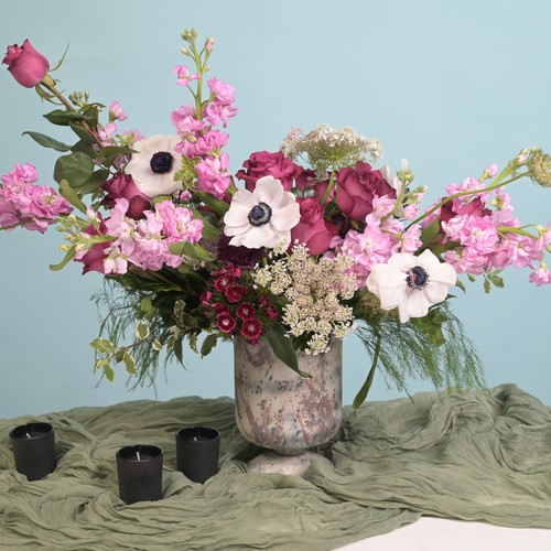White anemones pink stock and burgundy roses in a marble urn for luxury flower delivery Cary